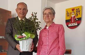 Marie-Luise Steube, die Vorsitzende der Anni-Berger-Stiftung in Bad Langensalza, übergibt Oberbürgermeister Knut Kreuch im Gothaer Rathaus eine Rose.